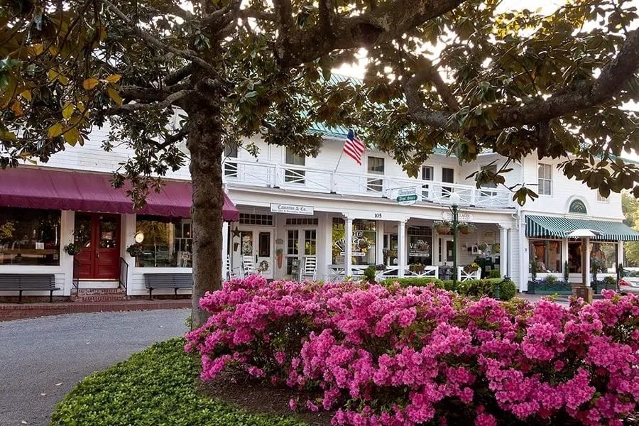 White clapboard shops, rocking chairs and azaleas in bloom in the Village of Pinehurst